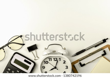 office supplies or stationery on white office table in the morning. - top view with copy space.