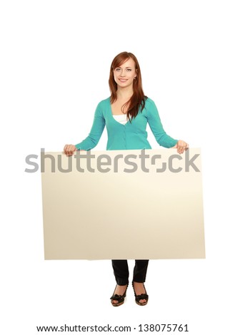 Portrait of a casual young woman holding blank card - over white background.