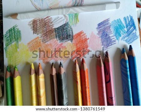 six pairs of colored pencils lie next to the interval, painting on paper with colored spots, creative environment, fine arts, painting, drawing, graphics