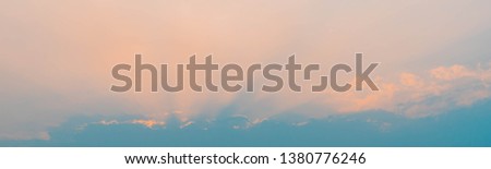 Bright Twilight Sky Banner Background with Colorful Orange Sky and Light of the Sun. Background with Blank Copy Space. 