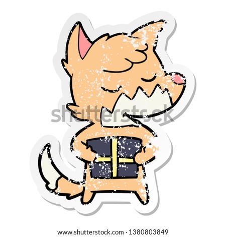 distressed sticker of a friendly cartoon fox with christmas present