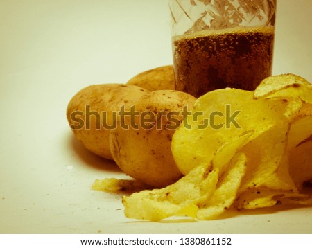 potato chips and lemonade on a light background