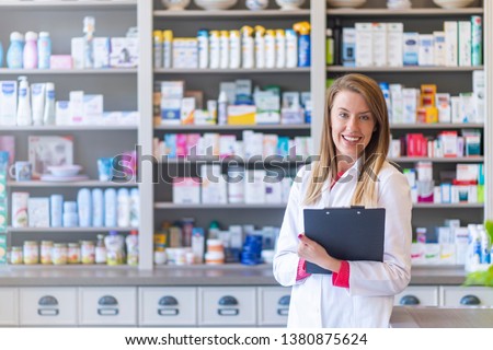 Hospital pharmacist worker. Portrait of cheerful smiling female pharmacist in pharmacy drugstore. Female pharmacists working in warehouse depot. Pharmacist posing chemist's shop 