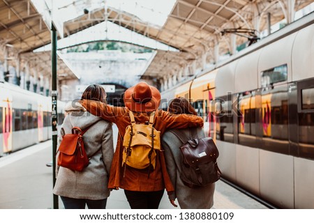 
A group of young friends waiting relaxed and carefree at the station in Porto, Portugal before catching a train. Travel photography. Lifestyle.