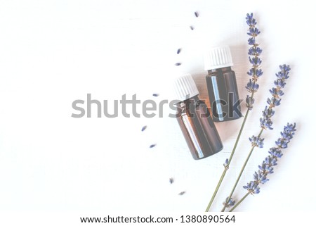 Dried lavender with a bottle of essential oil on white background.