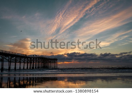 sunsetting behind a pier in California