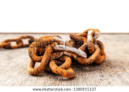 Rusty chains placed on a wooden tab