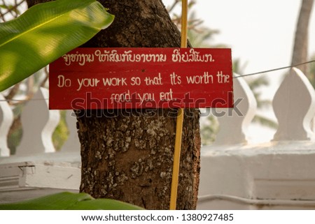 Inspirational message on grounds of Buddhist Temple in Luang Prabang, Laos.