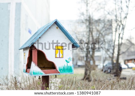 spring morning. a birdhouse in the form of a hut.