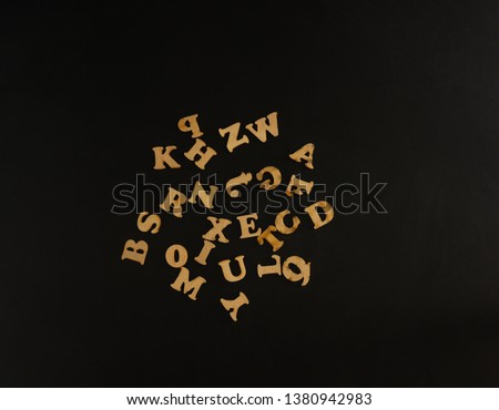 wooden letters on black and blue floor
