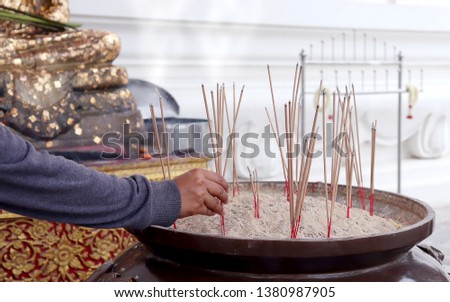 The hands of Asian women who burn incense to be a fortune in the concept of hope.