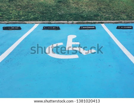 Parking for disabled people with blue and white color on street with empty space. symbol of handicapped.

