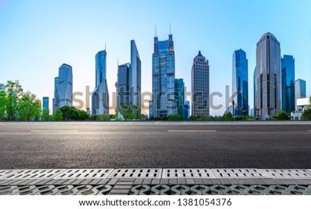 Shanghai modern commercial office buildings and empty asphalt road at night,panoramic view