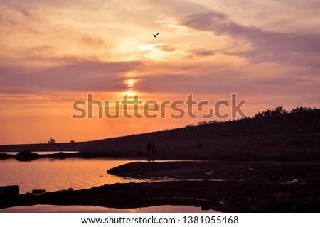 Nyari dam, Rajkot, India- sunset silhouette with beautiful sky. Royalty-Free Stock Photo #1381055468