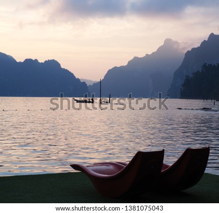 Overlooking the sea in evening with a mountain backdrop.