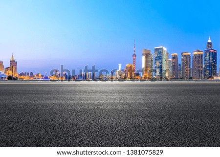Shanghai modern commercial office buildings and asphalt road at night