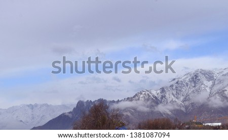 the picture of clouds sky snow and mountains