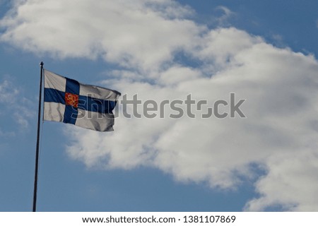Finlands flag floating against the blue sky