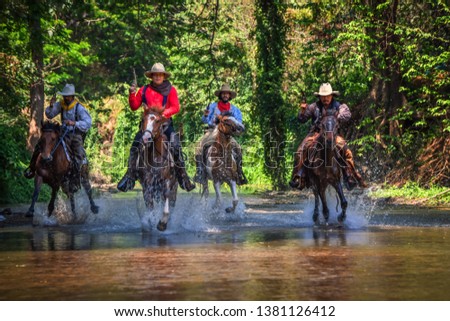 Pictures of many men wearing cowboy clothes, riding horses and traveling across the river