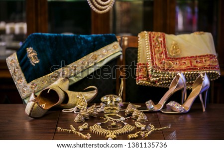 Indian bride and groom wedding outfits and jewelry with shoes Royalty-Free Stock Photo #1381135736