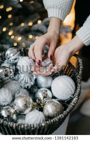 New Year 2020. Woman holds Christmas decorations for the Christmas tree. postcard picture. Christmas lights