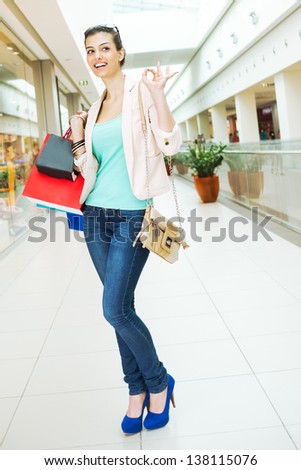Shopping time, attractive woman showing ok sign