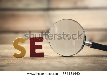 Colorful word Seo with magnifying glass. Search engine optimisation concept