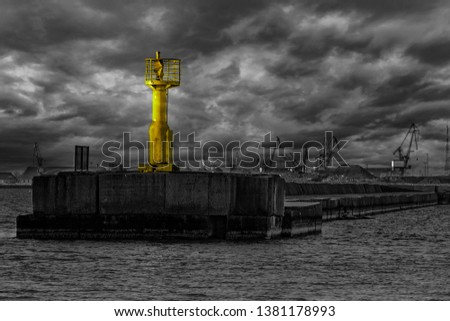 Black white photo with highlighted yellow lighthouse. Color splash photo.
