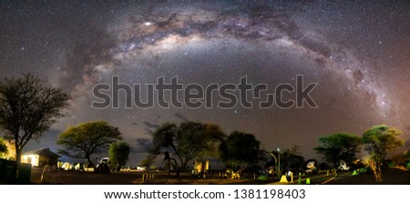 Panoramic view of Milky way and Galactic core over Etosha camping, Namibia.