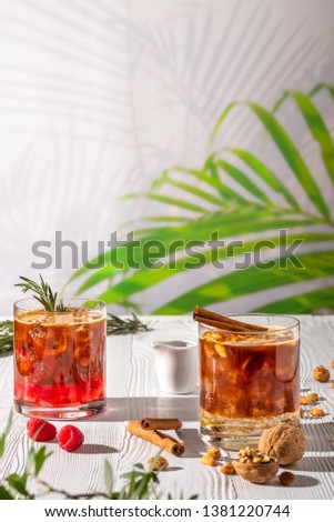 Variations of espresso-tonic refreshing drink with different fruits and syrups on wooden table under morning sun
