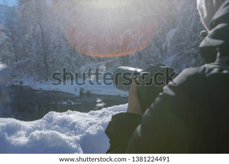 The photographer takes a photo of the beautiful landscape of Yosemite Valley in winter time.