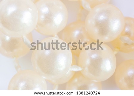 Pearl beads closeup. Light macro photography is suitable as a background. Top view