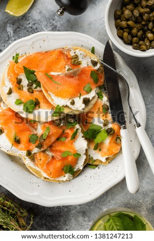 Snack toasts with salmon and cream cheese served on plate on grey marble tabletop– stock image