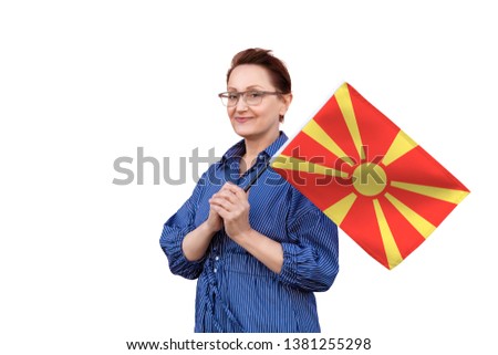 Macedonia flag. Woman holding Macedonian flag. Nice portrait of middle aged lady 40 50 years old holding a large flag isolated on white background.