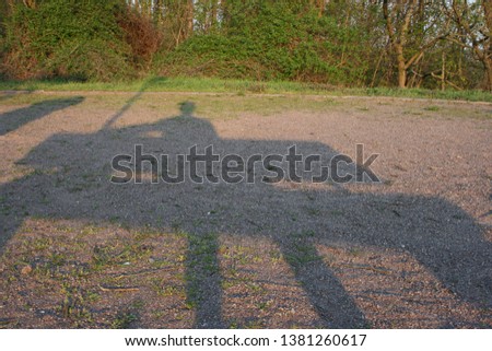 The shadow of a man sitting alone