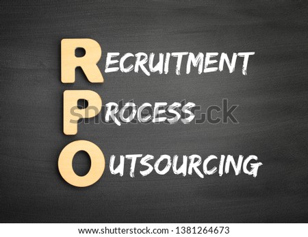 Wooden alphabets building the word RPO - Recruitment Process Outsourcing acronym on blackboard