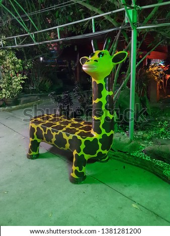 Furniture. Funny giraffe designed bench for kids in central Thailand