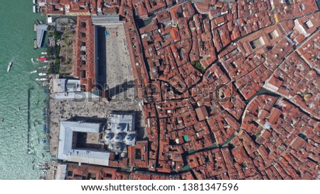 Aerial drone photo of iconic and unique Saint Mark's square or Piazza San Marco featuring Doge's Palace, Basilica and Campanile as seen from very high, Venice, Italy