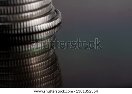 A stack of coins on a reflective surface. Macro photo