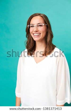 Happy glasses girl against blue background