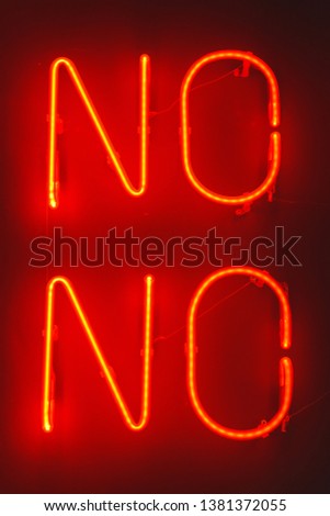 The red neon sign is NOT on the dark wall. Decorative element. Neon sign in the coffee shop. Decorative luminous inscription on the wall.