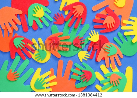 Abstract background of funky foam hand cutouts of different sizes in red, orange, yellow, green and blue