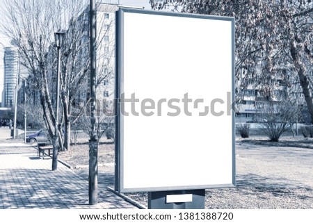 Vertical small billboard in the city on the sidewalk. Mock up for your advertising or announcements