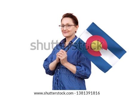 Colorado flag. Woman holding Colorado state flag. Nice portrait of middle aged lady 40 50 years old holding a large state flag isolated on white background.