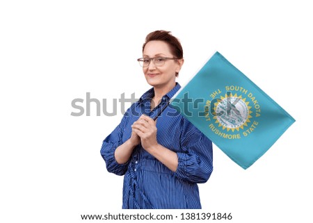 South Dakota flag. Woman holding South Dakota state flag. Nice portrait of middle aged lady 40 50 years old holding a large state flag isolated on white background.