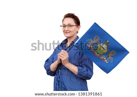 Pennsylvania flag. Woman holding Pennsylvania state flag. Nice portrait of middle aged lady 40 50 years old holding a large state flag isolated on white background.