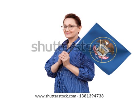 Utah flag. Woman holding Utah state flag. Nice portrait of middle aged lady 40 50 years old holding a large state flag isolated on white background.
