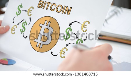 Hands holding a paper showing a bitcoin concept