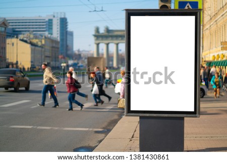 Vertical billboard lightbox in the city. for placing the MOCKUP advertisement with people in the background crossing the road. Running shopping people in the background store discounts