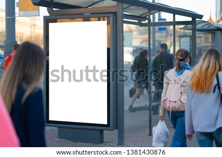 Vertical billboard lightbox in the city. for placing the MOCKUP advertisement with people in the background advertising in the bus shelter